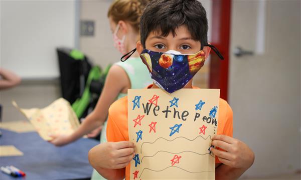Boy holds up Constitution craft
